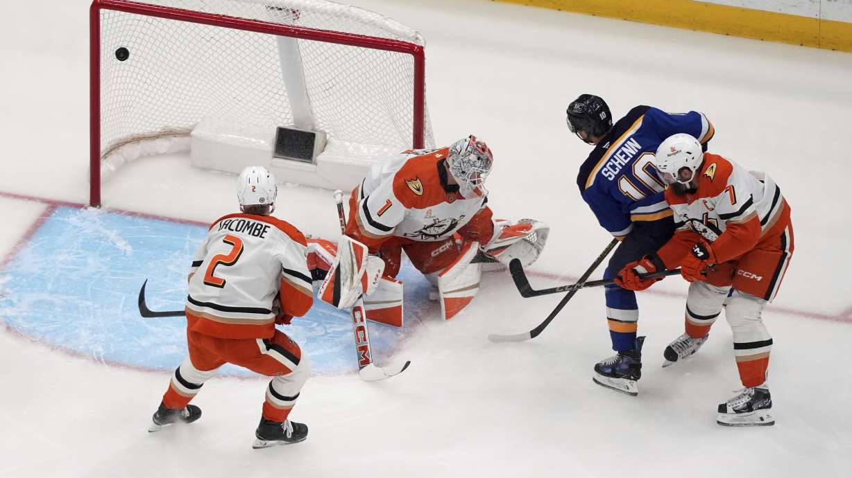 St. Louis Blues' Brayden Schenn (10) scores past Anaheim Ducks goaltender Lukas Dostal (1) as Ducks' Jackson LaCombe (2) and Radko Gudas (7) watch during the first period of an NHL hockey game Sunday, March 16, 2025, in St. Louis.