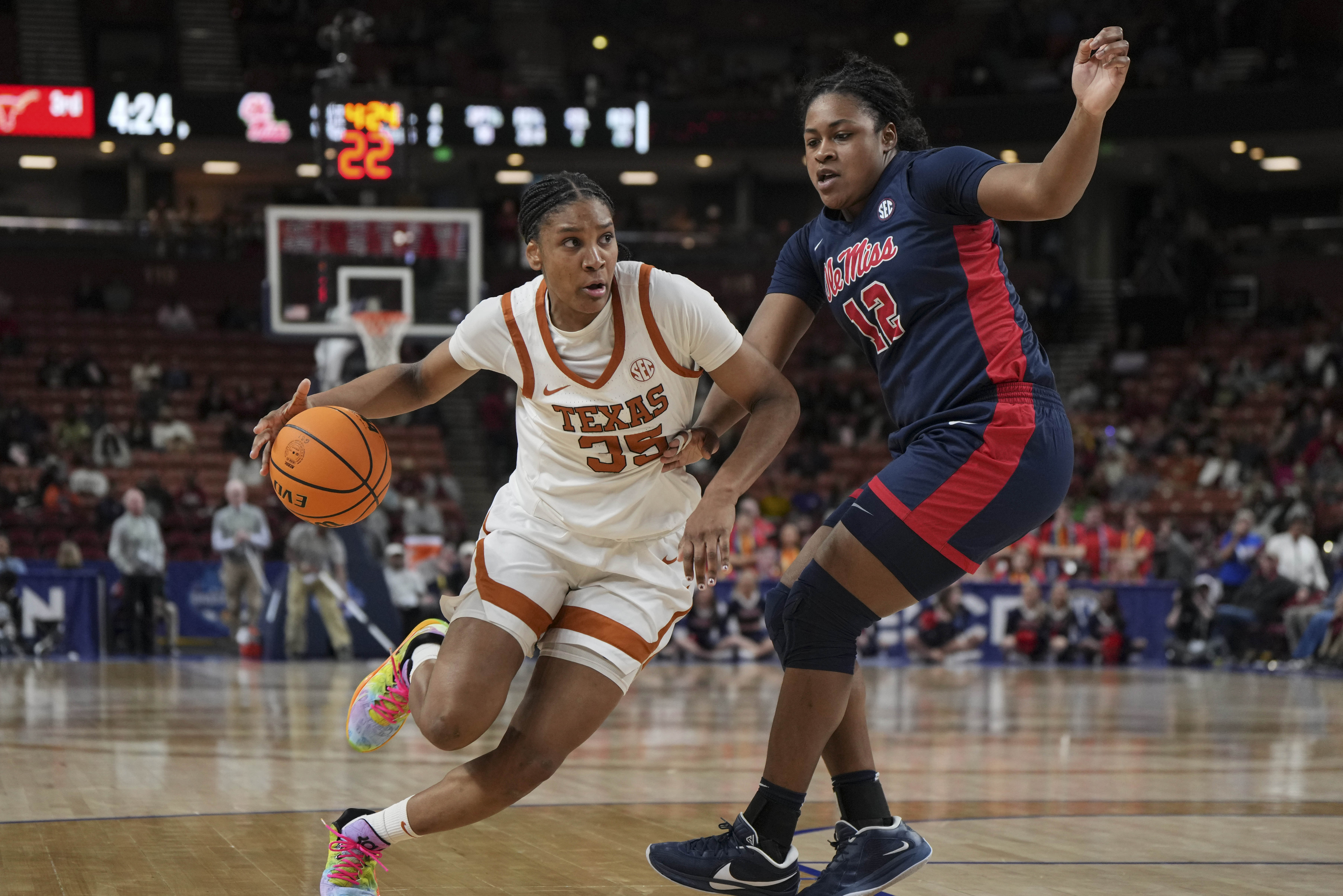 Texas forward Madison Booker (35) drives around Mississippi forward Christeen Iwuala (12) during an NCAA college basketball game in the quarterfinals of the Southeastern Conference tournament, Friday, March 7, 2025, in Greenville, S.C.