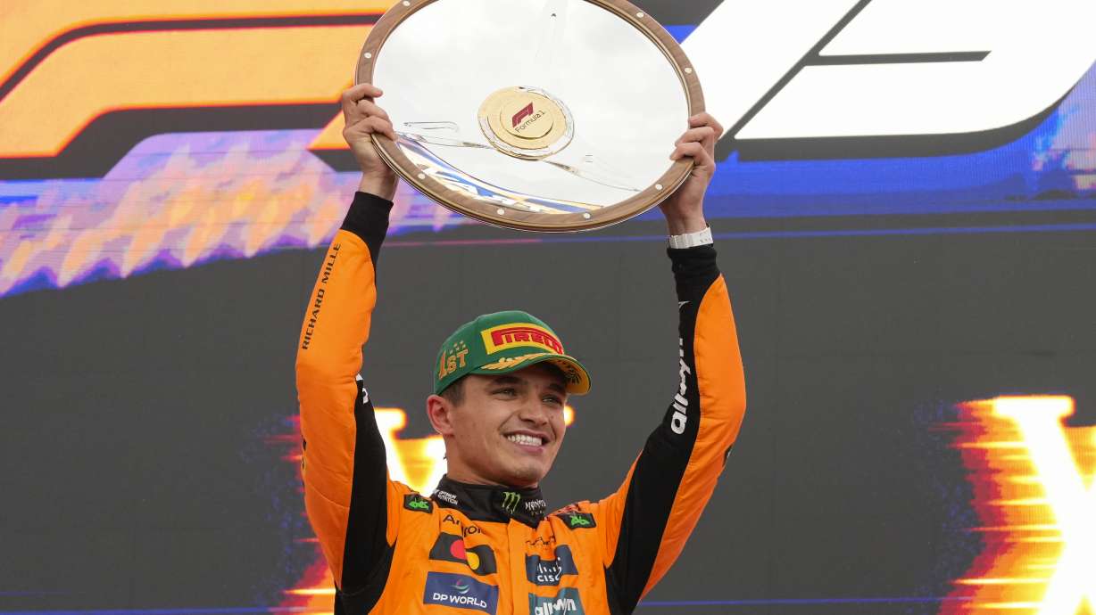 McLaren driver Lando Norris of Britain celebrates on the podium after winning the Australian Formula One Grand Prix at Albert Park, in Melbourne, Australia, Sunday, March 16, 2025.