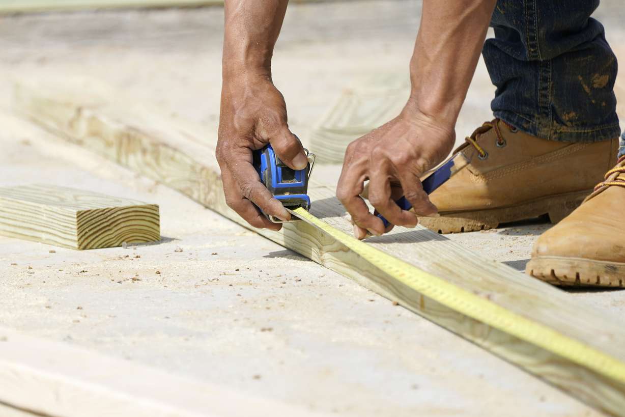 A beam is measured and marked at a housing site in Madison County, Miss., March 16, 2021.