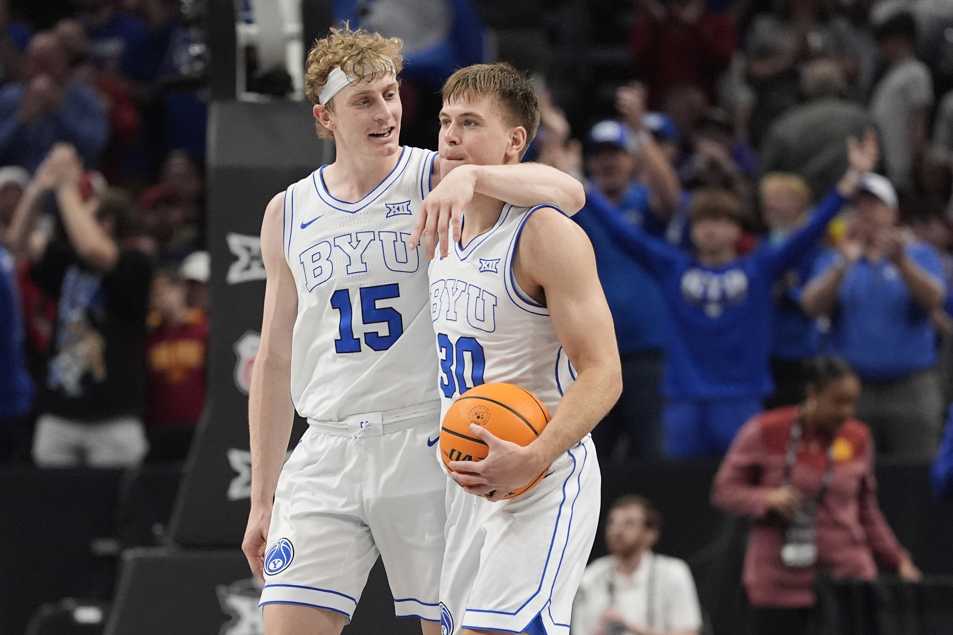 Brigham Young's Richie Saunders (15) and Dallin Hall (30) celebrate after defeating Iowa State during an NCAA college basketball game in the quarterfinal round of the Big 12 Conference tournament, Thursday, March 13, 2025, in Kansas City, Mo.