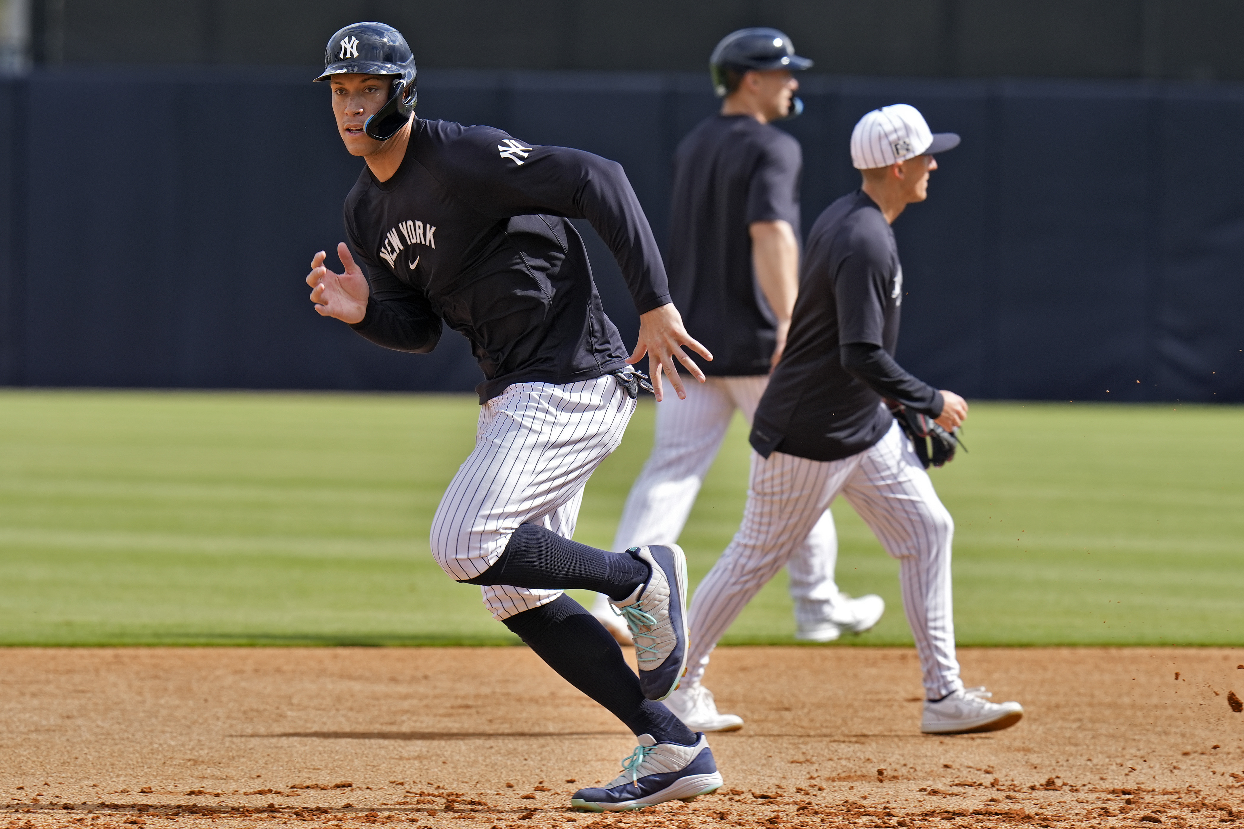 New York Yankees outfielder Aaron Judge, left, takes off running during a spring training baseball workout Thursday, Feb. 20, 2025, in Tampa, Fla.
