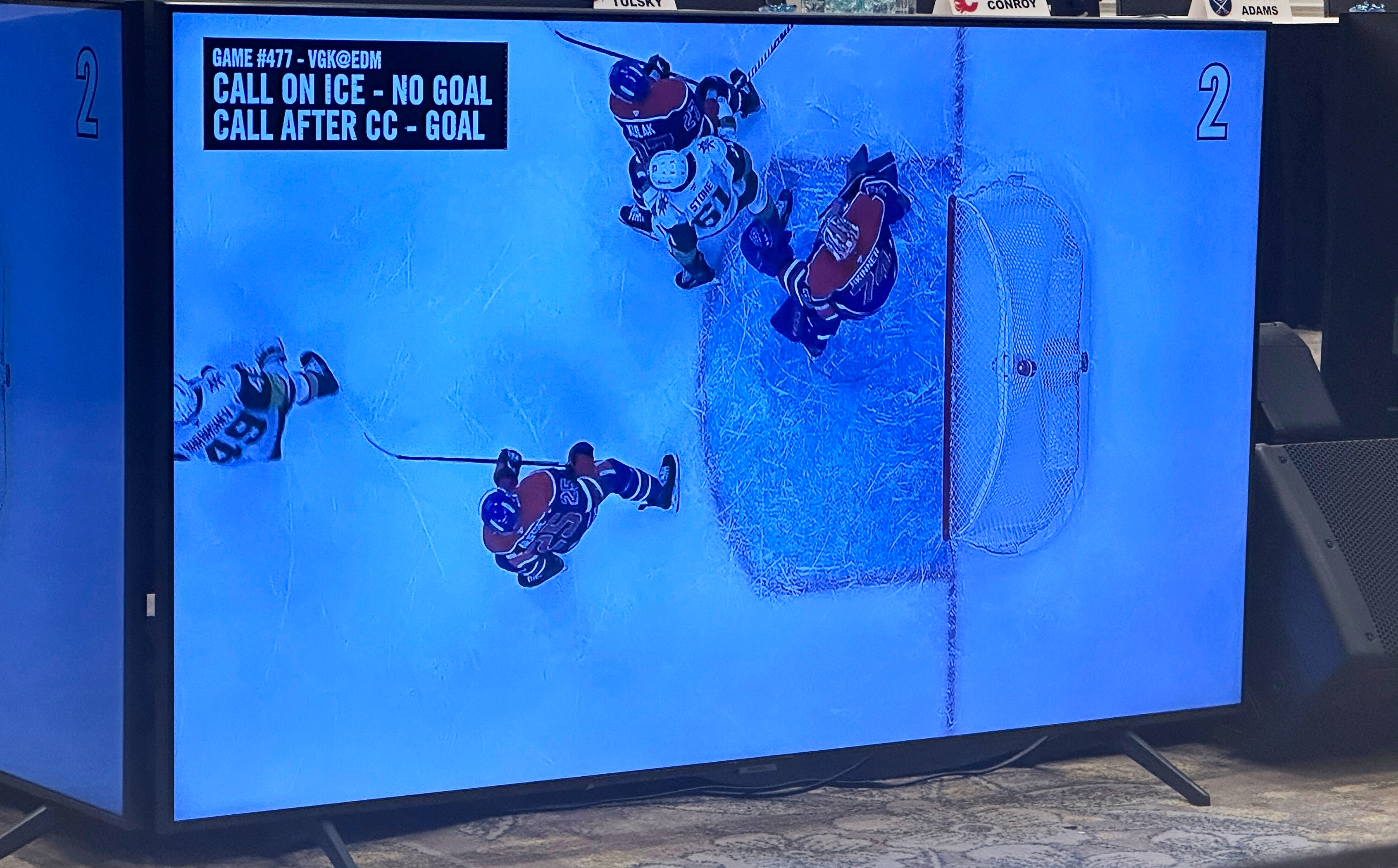A monitor at the NHL general mangers meetings, Monday, March 17 2025, in Manaplan, Fla., shows an overhead view of a coach's challenge video review for goaltender interference from the Vegas Golden Knights' NHL hockey game at the Edmonton Oilers on Dec. 14, 2024, that was one of roughly 55 clips shown during the first session of their annual spring meeting.