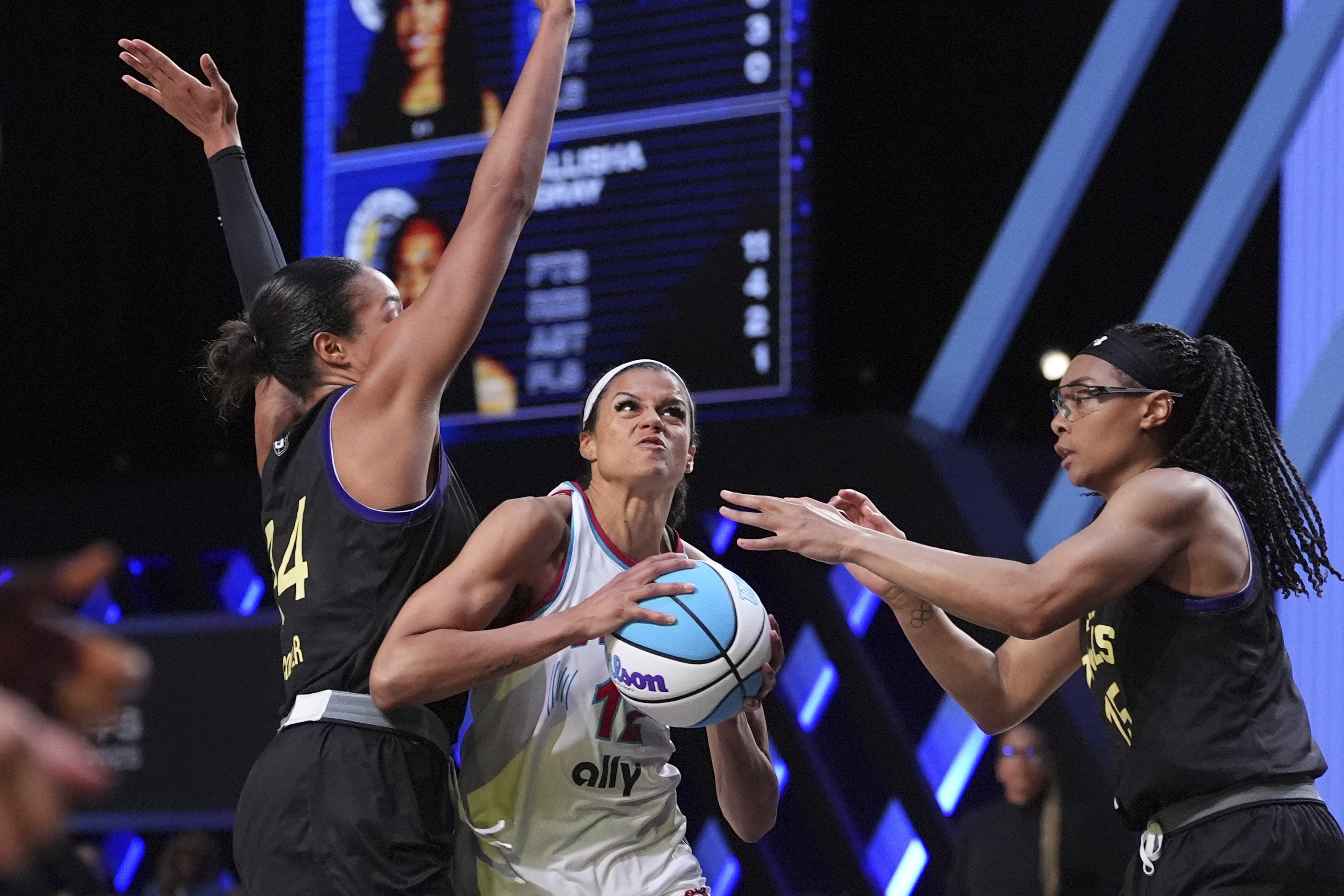 Vinyl wing Rae Burrell, center, comes under pressure from Lunar Owls forward Napheesa Collier, left, and wing Allisha Gray in their Unrivaled 3-on-3 basketball semifinal, Sunday, March 16, 2025, in Medley, Fla.