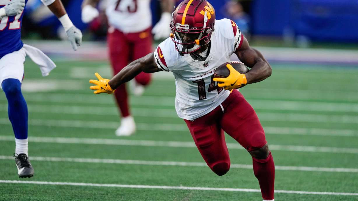FILE - Washington Commanders wide receiver Olamide Zaccheaus (14) carries the ball against the New York Giants during the second half of an NFL football game, Sunday, Nov. 3, 2024, in East Rutherford, N.J.