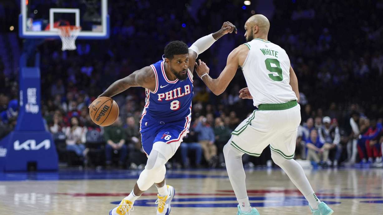 Philadelphia 76ers' Paul George, left, tries to get past Boston Celtics' Derrick White during the second half of an NBA basketball game, Thursday, Feb. 20, 2025, in Philadelphia.