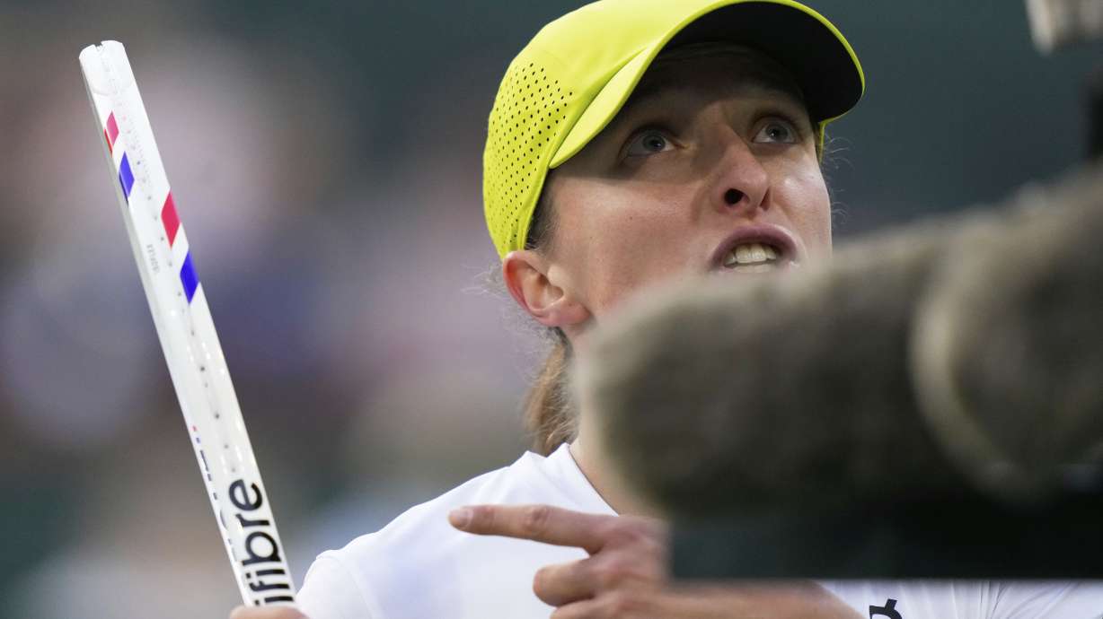 Iga Swiatek, of Poland, gestures while talking with the chair umpire as she plays against Mirra Andreeva, of Russia, during the semifinals at the BNP Paribas Open tennis tournament Friday, March 14, 2025, in Indian Wells, Calif.