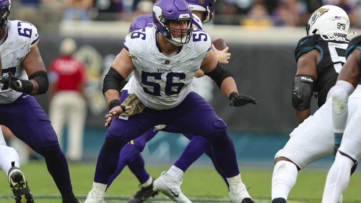 FILE - Minnesota Vikings center Garrett Bradbury (56) rises up to block during an NFL football game against the Jacksonville Jaguars, Nov. 10, 2024, in Jacksonville, Fla.