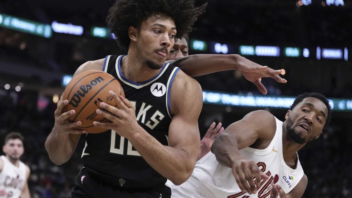 Milwaukee Bucks' Jericho Sims grabs a rebound in front of Cleveland Cavaliers' Donovan Mitchell during the first half of an NBA basketball game Sunday, Mar. 9, 2025, in Milwaukee.