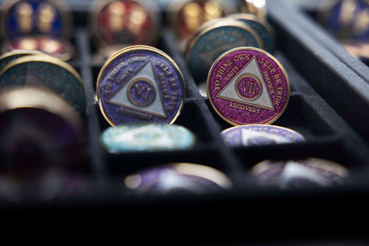 Sobriety tokens, or "chips,” which are given for specified lengths of sobriety, are displayed in the bookstore of the Alano Club in Murray on March 4.