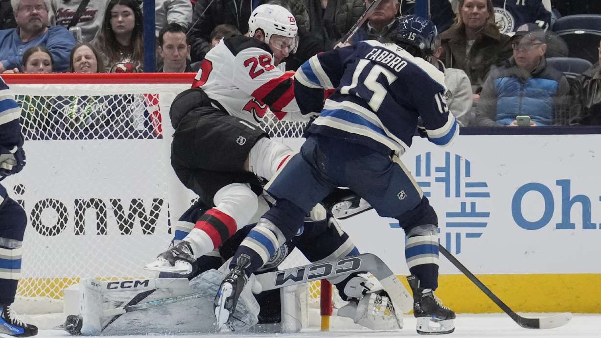 New Jersey Devils right wing Timo Meier (28) falls into Columbus Blue Jackets goaltender Jet Greaves, rear, next to defenseman Dante Fabbro (15) after scoring in the second period of an NHL hockey game Monday, March 17, 2025, in Columbus, Ohio.