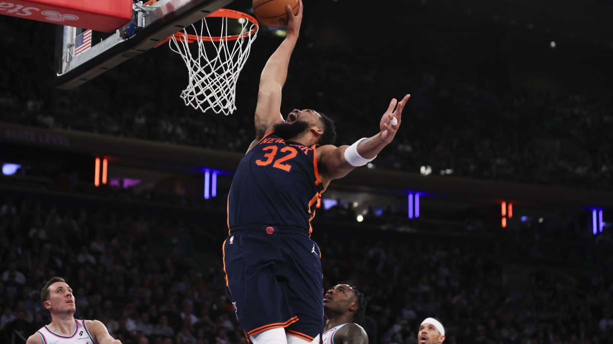New York Knicks center Karl-Anthony Towns (32) dunks during the first half of an NBA basketball game against the Miami Heat, Monday, March 17, 2025, in New York.