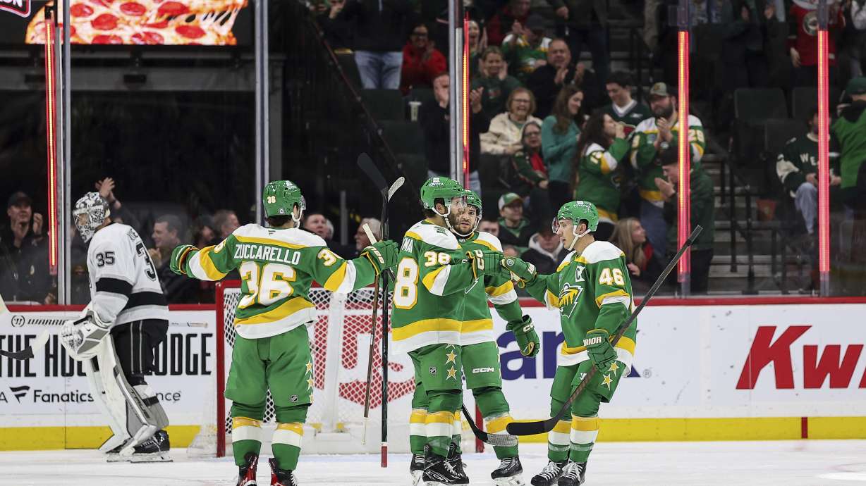 Minnesota Wild right wing Ryan Hartman (38) celebrates with teammates after his goal during the second period of an NHL hockey game against the Los Angeles Kings, Monday, March 17, 2025, in St. Paul, Minn.