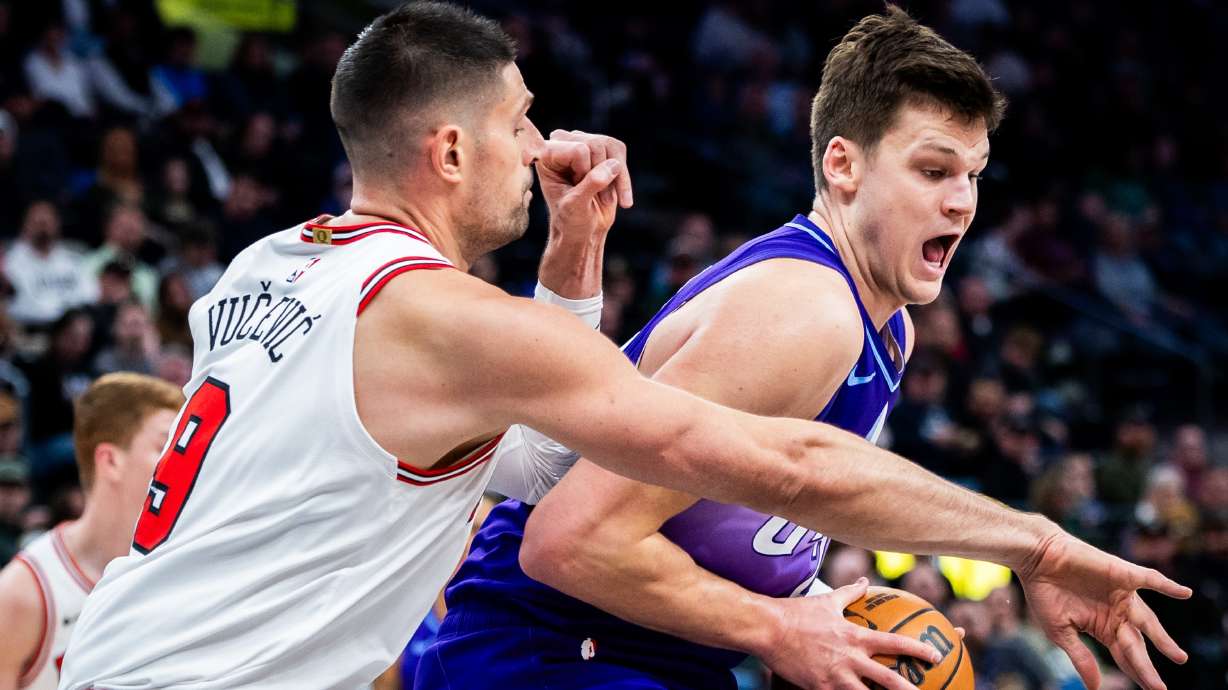 Utah Jazz center Walker Kessler (24) prepares to turn toward the basket to make a shot while guarded by Chicago Bulls center Nikola Vucevic (9) during an NBA game at the Delta Center in Salt Lake City on Monday, March 17, 2025.