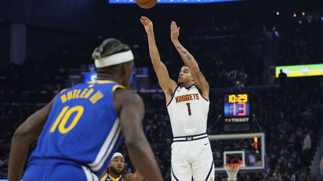 Denver Nuggets forward Michael Porter Jr. (1) shoots a 3-point basket next to Golden State Warriors guard Moses Moody (4) during the first half of an NBA basketball game Monday, March 17, 2025, in San Francisco.