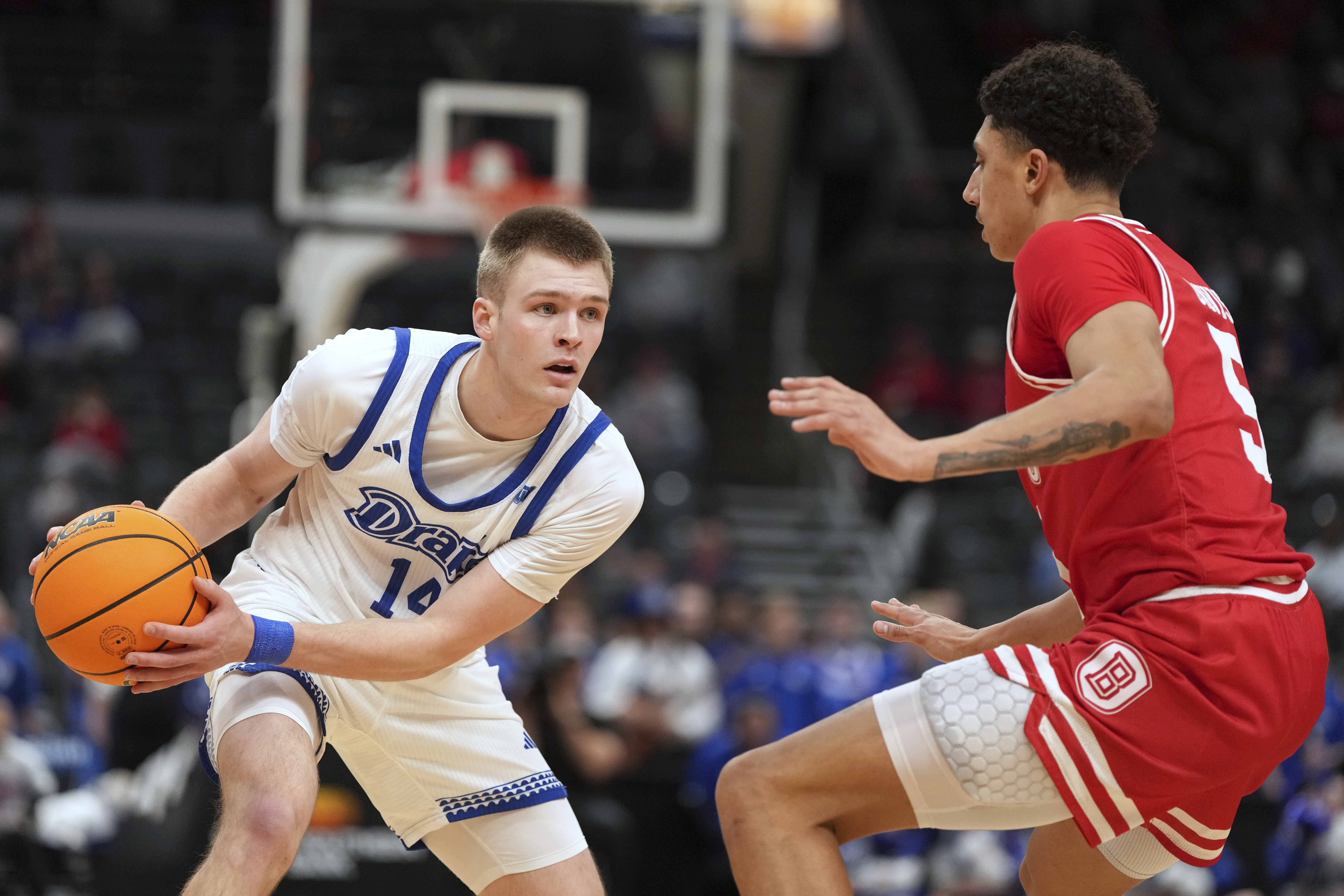 Drake's Bennett Stirtz (14) looks to pass as Bradley's Christian Davis (5) defends during the first half of the championship game in the Missouri Valley Conference NCAA college basketball tournament Sunday, March 9, 2025, in St. Louis.