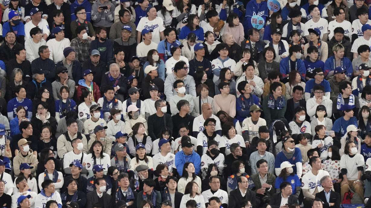 Fans watch the Los Angeles Dodgers play the Chicago Cubs in the first inning of an MLB Japan Series baseball game in Tokyo, Japan, Tuesday, March 18, 2025.