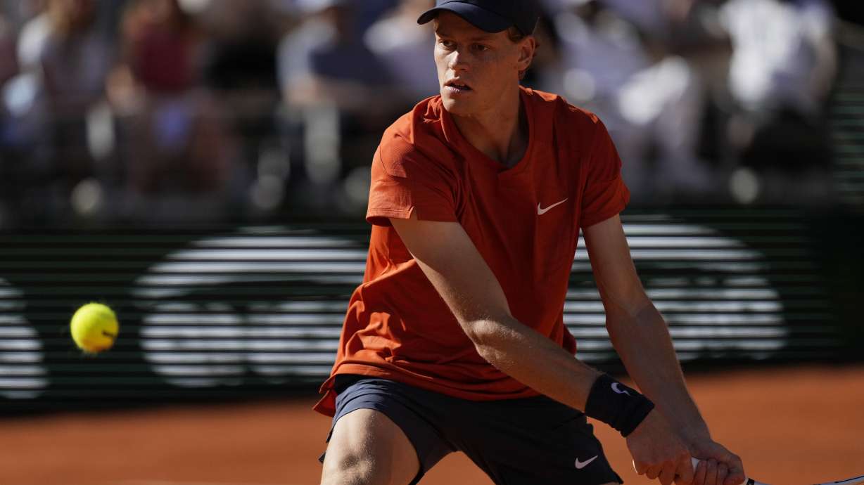 FILE - Italy's Jannik Sinner plays a shot against Spain's Carlos Alcaraz during their semifinal match of the French Open tennis tournament at the Roland Garros stadium in Paris, Friday, June 7, 2024.