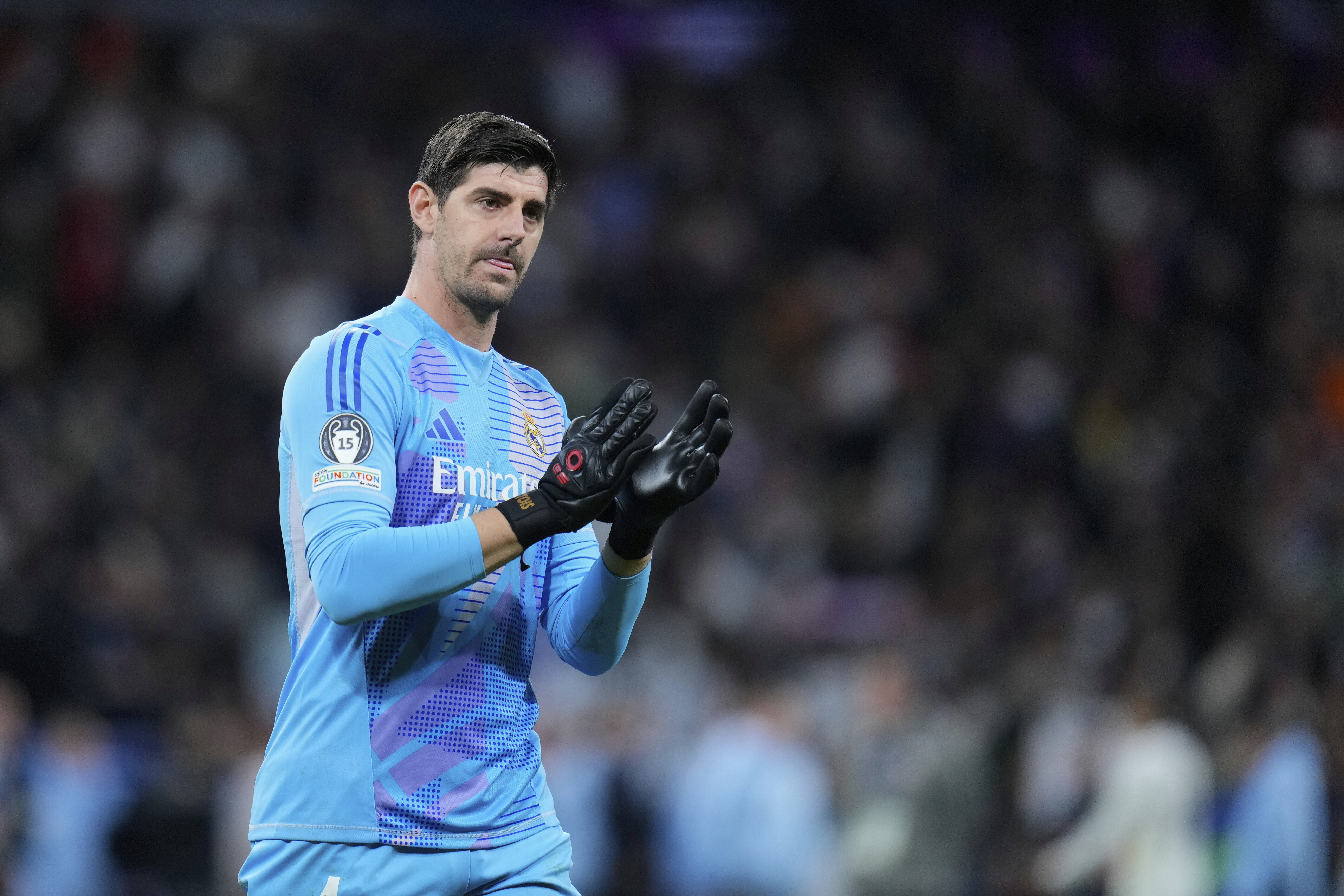 Real Madrid's goalkeeper Thibaut Courtois applauds fans at the end of the Champions League round of 16 first leg soccer match between Real Madrid and Atletico Madrid at the Bernebeu stadium in Madrid, Spain, Tuesday, March 4, 2025.
