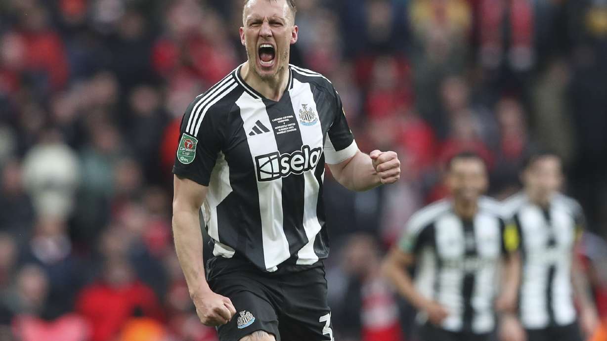 Newcastle's Dan Burn celebrates after scoring the opening goal during the EFL Cup final soccer match between Liverpool and Newcastle at Wembley Stadium in London, Sunday, March 16, 2025.