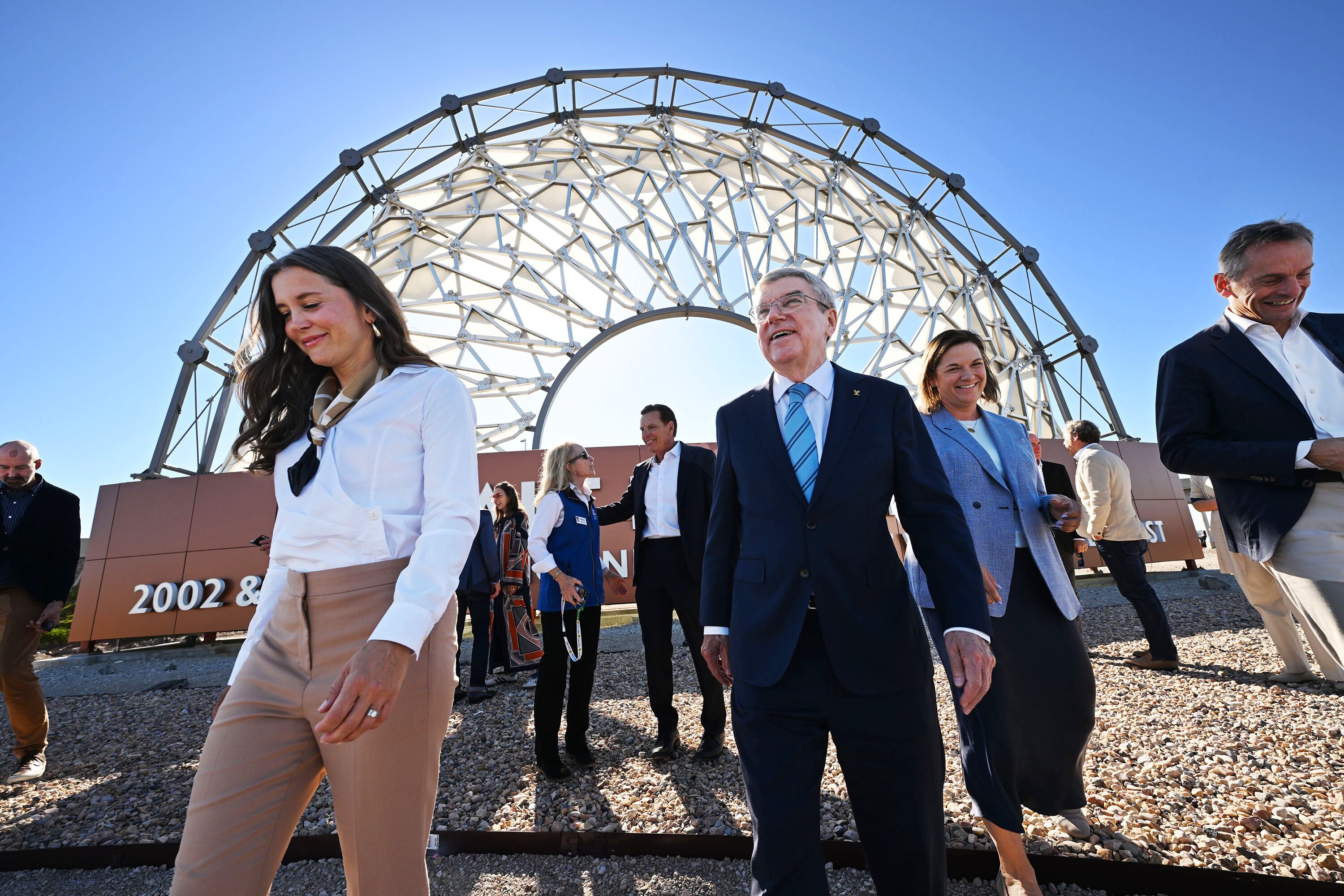 Salt Lake City Mayor Erin Mendenhall walks ahead of International Olympic Committee President Thomas Bach at the Salt Lake City International Airport, Sept. 27, 2024. A change in the committee could affect the 2034 Games.