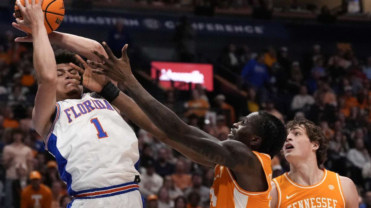 Florida guard Walter Clayton Jr. (1) takes a rebound against Tennessee forward Felix Okpara (34) during the first half of an NCAA college basketball game in the final round of the Southeastern Conference tournament, Sunday, March 16, 2025, in Nashville, Tenn.