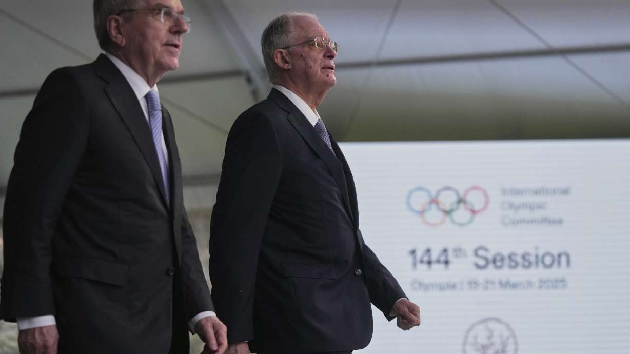 International Olympic Committee President Thomas Bach, left, and Greece's President Constantine Tassoulas arrive at the opening ceremony of the 144th IOC session, which will elect the new IOC President, at the Olympic Academy in ancient Olympia, western Greece, Tuesday, March 18, 2025.