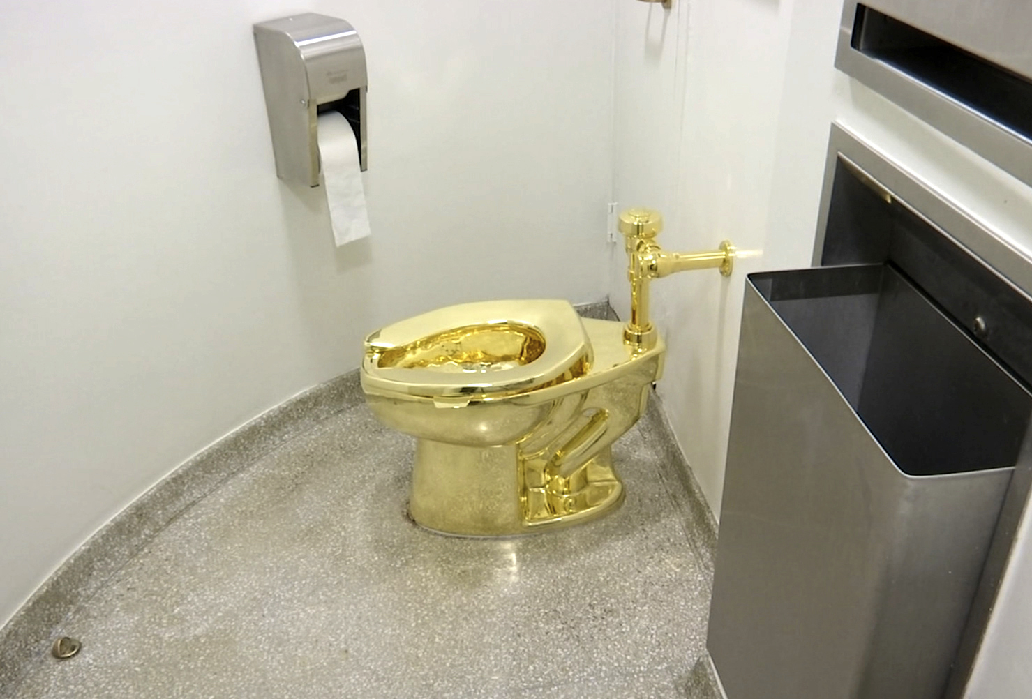This screenshot made from a video shows the 18-karat toilet, titled "America," by Maurizio Cattelan in the restroom of the Solomon R. Guggenheim Museum in New York, Sept. 16, 2016. Tuesday, a British man was found guilty of stealing the golden toilet.