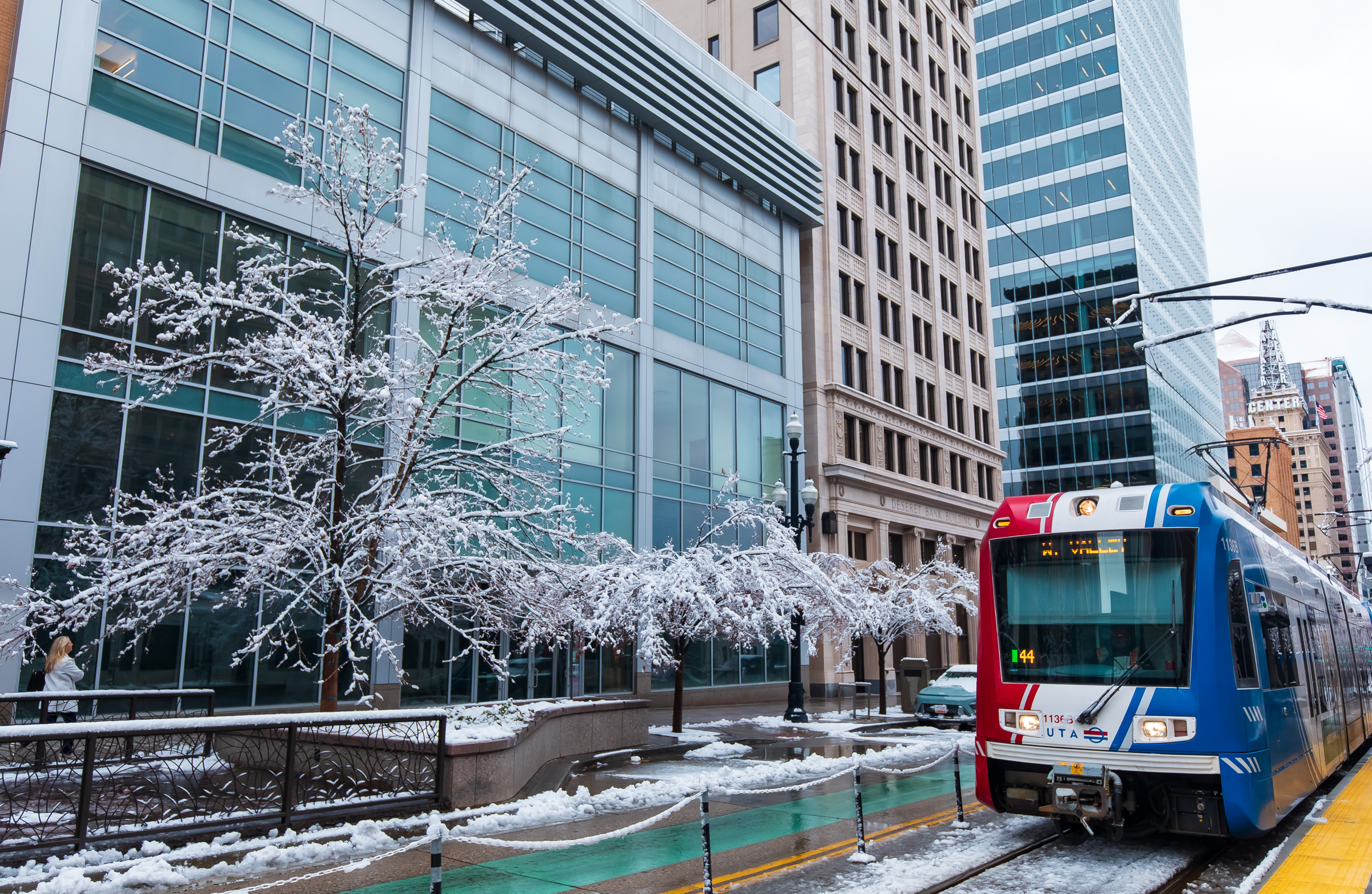 A TRAX train passes through snow-covered trees in downtown Salt Lake City on Tuesday.