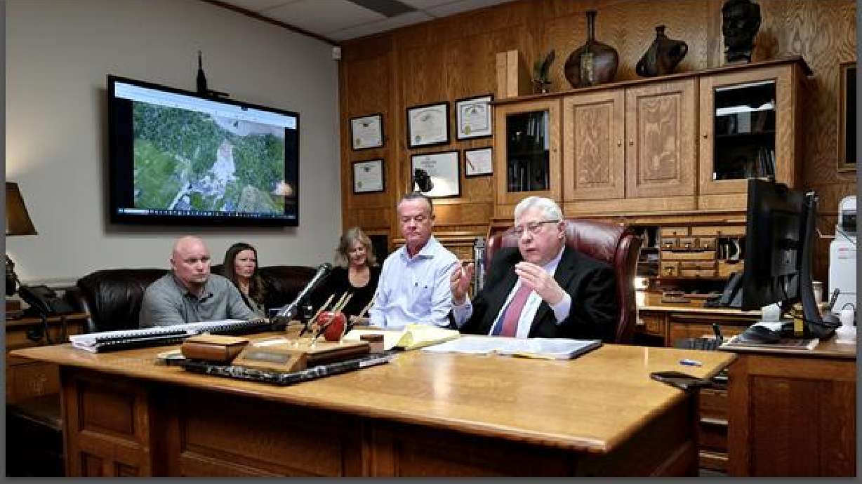 Two of three Fruit Heights couples, with attorney Robert Sykes, filed a lawsuit against the city and state on Tuesday, alleging a housing development has ignored geological warnings and caused several dangerous mudslides in their backyards.