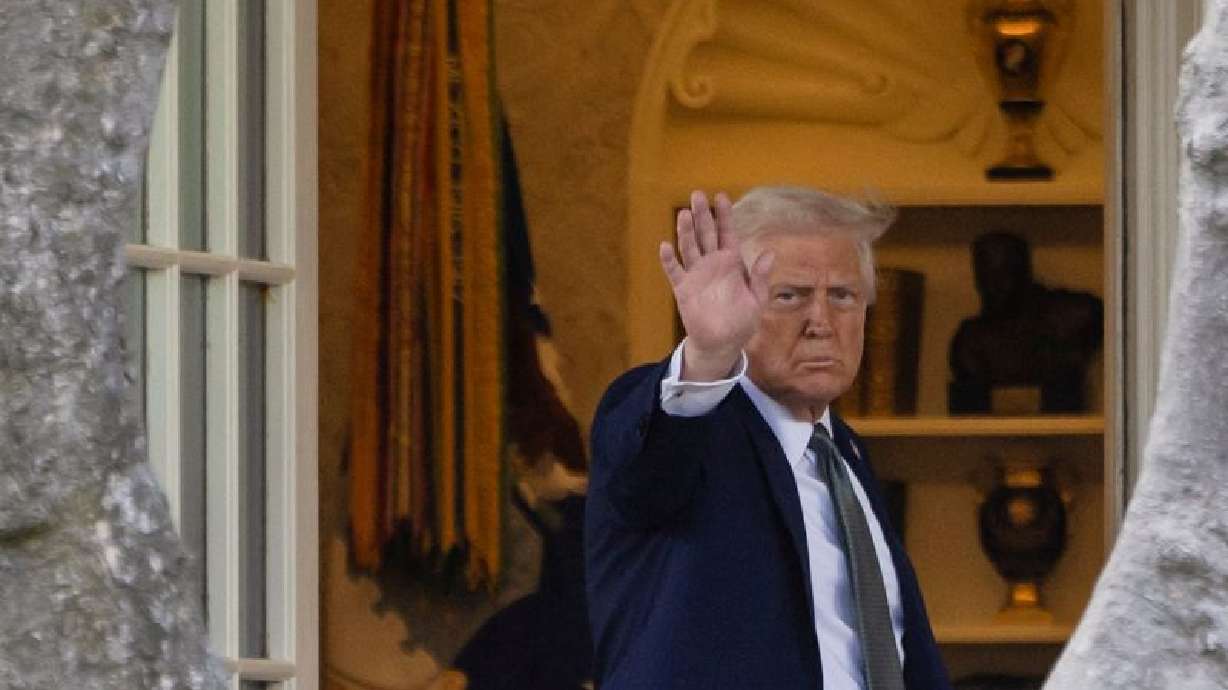 President Donald Trump waves as he returns to the White House after attending a board meeting at the Kennedy Center, in Washington, Monday.
