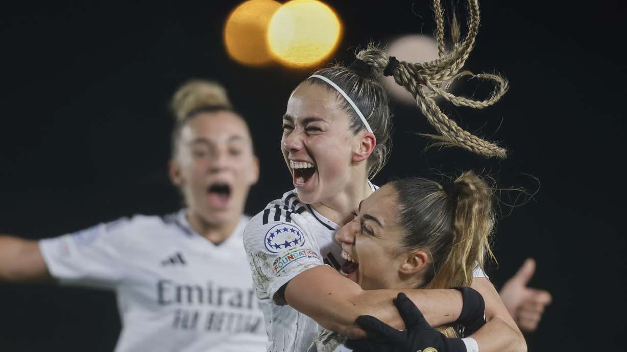 Real Madrid's Athenea del Castillo , centre, celebrates with Real Madrid's captain Olga Carmona, right, after scoring her side's second goal during the Women's Champions League quarterfinal first leg soccer match between Real Madrid and Arsenal at the Alfredo di Stefano stadium in Madrid, Spain, Tuesday March 18, 2025.