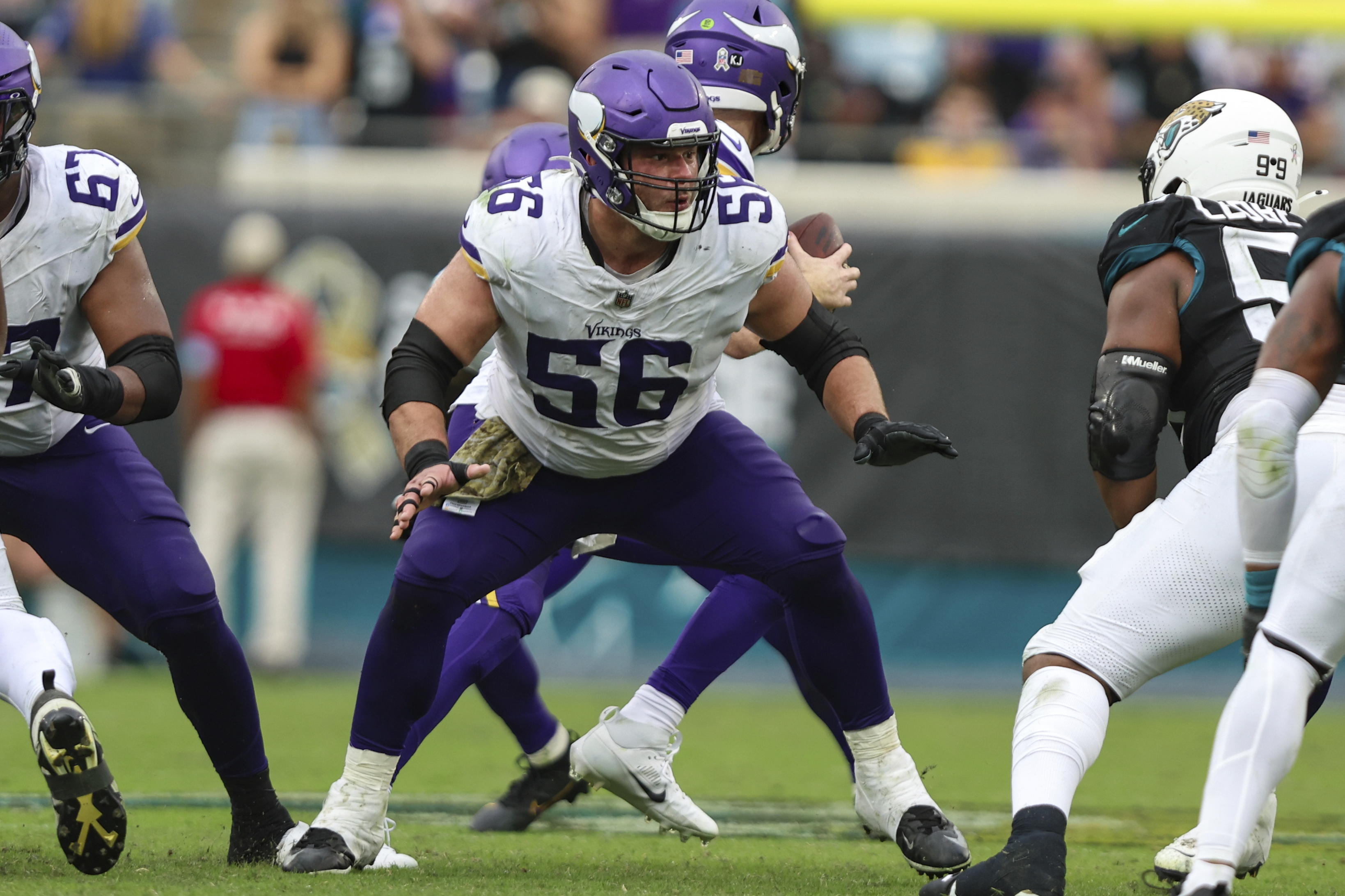FILE - Minnesota Vikings center Garrett Bradbury (56) rises up to block during an NFL football game against the Jacksonville Jaguars, Nov. 10, 2024, in Jacksonville, Fla.