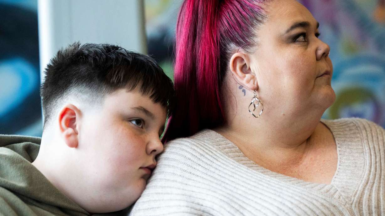 Abel Hardman, 11, and his mother, Trina Supp, listen to a press conference announcing a newly established bereavement support network for children suffering the death of a parent or caregiver, at The Sharing Place in Taylorsville on Tuesday.