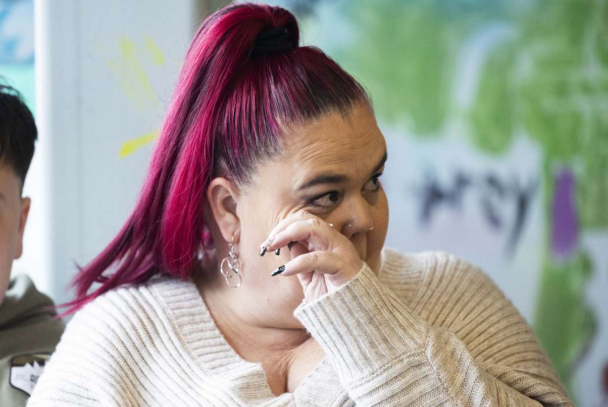Trina Supp wipes a tear from her eye while listening to a press conference announcing a newly established bereavement support network for children suffering the death of a parent or caregiver, at The Sharing Place in Taylorsville on Tuesday, March 18.