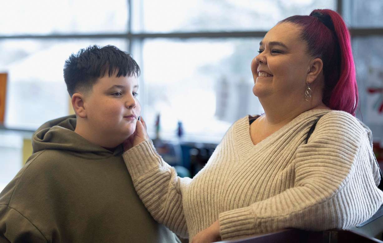 Trina Supp touches her her son Abel Hardman’s face while laughing together after a press conference announcing a newly established bereavement support network for children suffering the death of a parent or caregiver, at The Sharing Place in Taylorsville on Tuesday, March 18. Abel lost his father, Kyle Hardman, in 2022; he and his mother both found a supportive community at The Sharing Place that allowed them to process and begin to recover from his death.