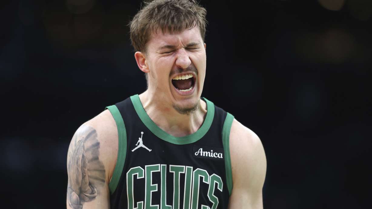 Boston Celtics' Baylor Scheierman reacts after making a 3-pointer during second half of an NBA basketball game against the Brooklyn Nets Tuesday, March 18, 2025, in Boston.