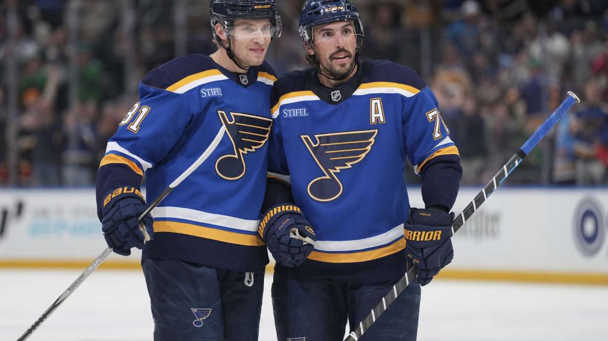 St. Louis Blues' Dylan Holloway, left, is congratulated by teammate Justin Faulk after scoring during the second period of an NHL hockey game against the Anaheim Ducks Sunday, March 16, 2025, in St. Louis.