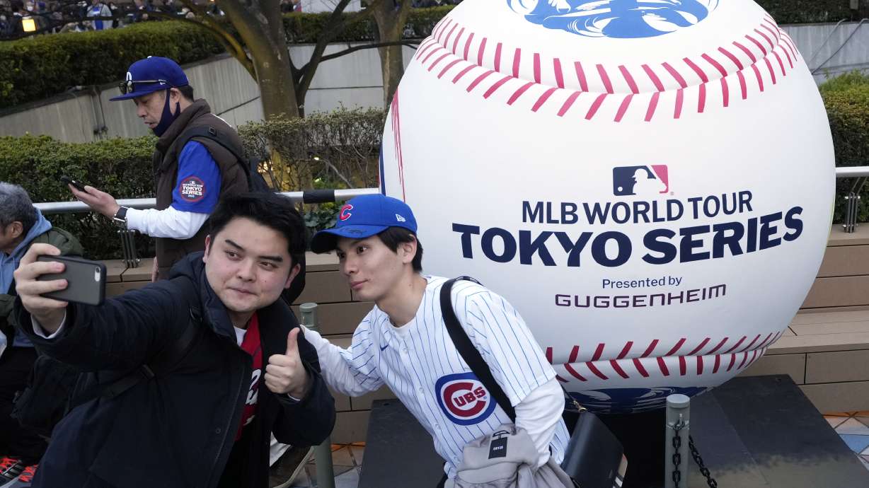 Fans of the Chicago Cubs take selfie at the Tokyo Dome ahead of an MLB Tokyo Series baseball game between the Los Angeles Dodgers and the Chicago Cubs, in Tokyo, Tuesday, March 18, 2025.