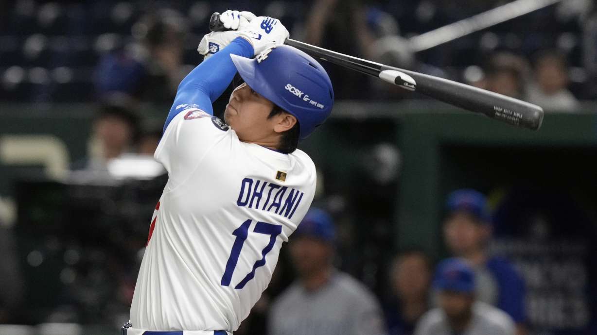 Los Angeles Dodgers' Shohei Ohtani follows through ona fly out to left in the first inning of an MLB Tokyo Series baseball game against the Chicago Cubs in Tokyo, Japan, Wednesday, March 19, 2025.