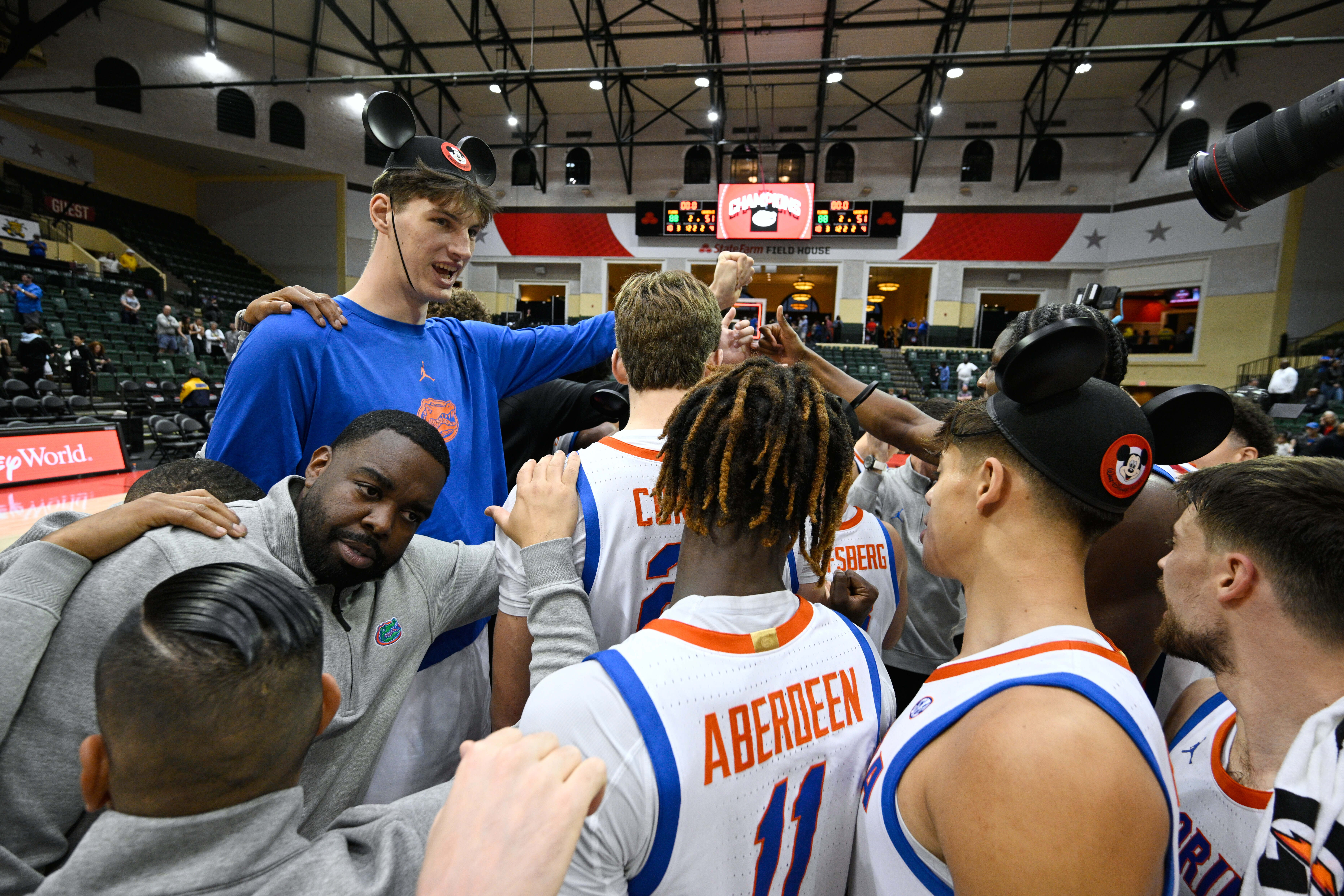 FILE - Florida center Olivier Rioux, upper left, huddles with teammates on the court after an NCAA college basketball game against Wichita State, Friday, Nov. 29, 2024, in Kissimmee, Fla.
