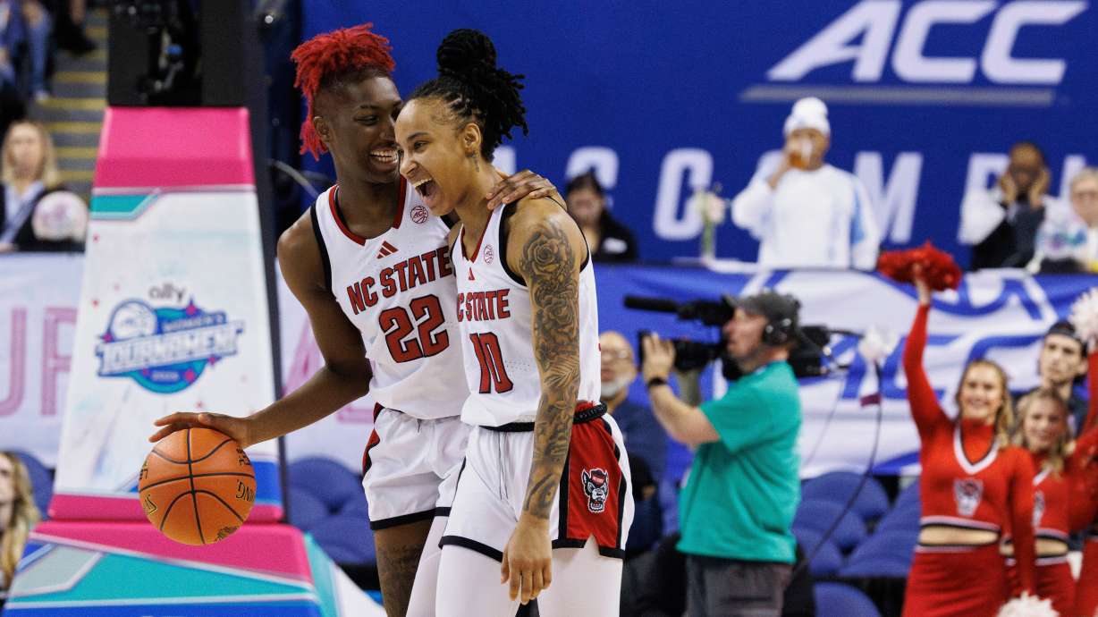 North Carolina State's Saniya Rivers (22) and Aziaha James (10) celebrate after beating North Carolina in an NCAA college basketball game in the semifinals of the Atlantic Coast Conference tournament in Greensboro, N.C., Saturday, March 8, 2025.