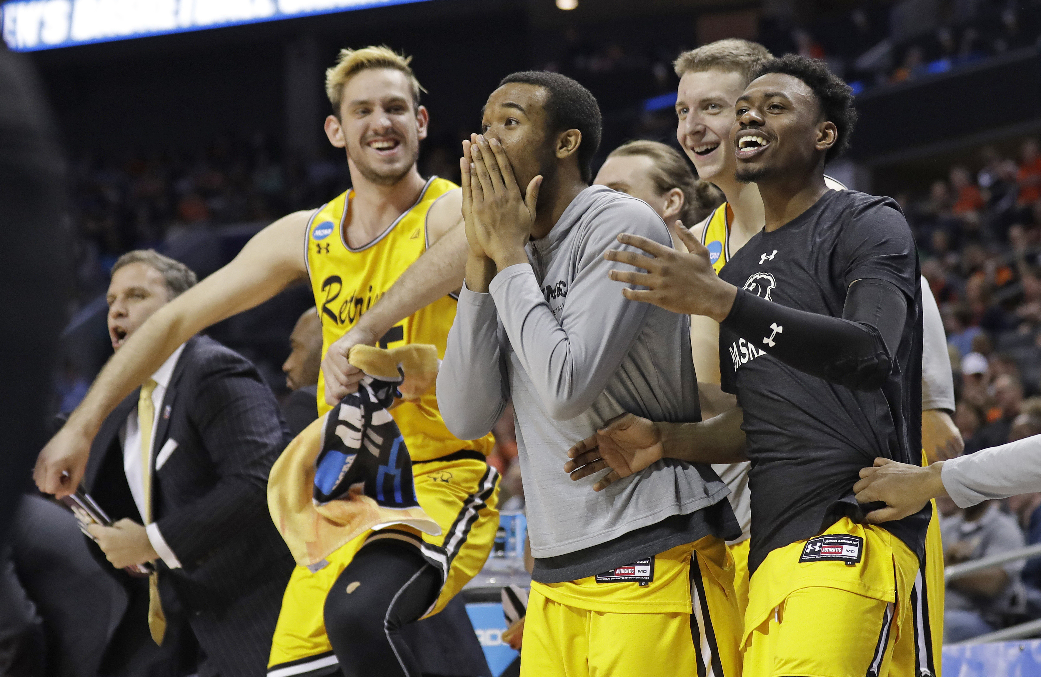 FILE - UMBC players celebrate a teammate's basket during the second half against Virginia in a first-round game in the NCAA men's college basketball tournament in Charlotte, N.C., March 16, 2018.
