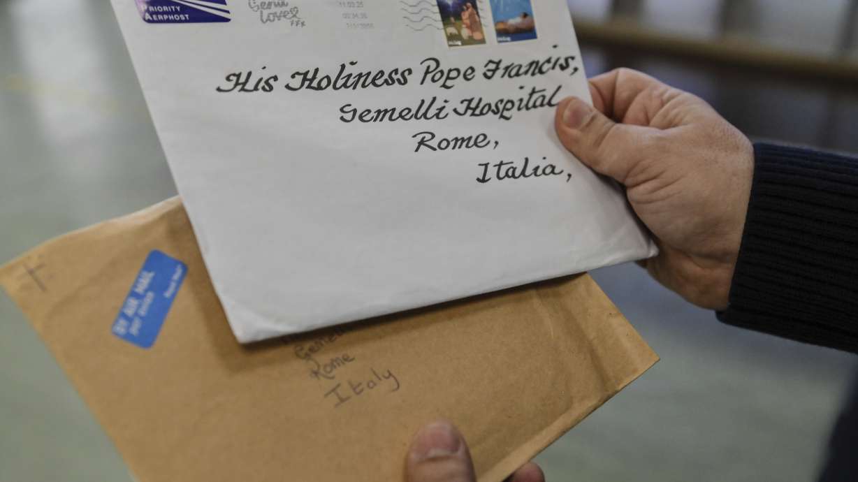 An employee of the Belsito postal distribution center in Rome sorts letters addressed to Pope Francis, who is currently being treated at Rome's Agostino Gemelli Polyclinic for bilateral pneumonia, Wednesday.