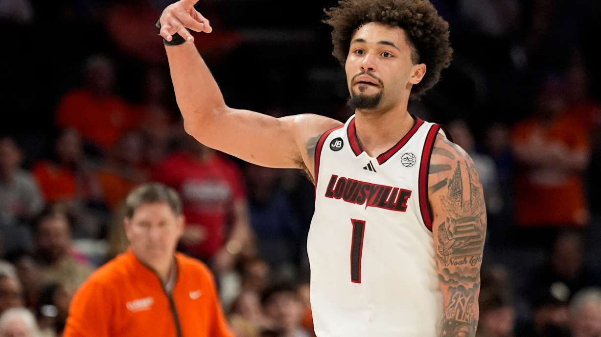 FILE - Louisville guard J'Vonne Hadley celebrates after scoring against the Clemson during the second half of an NCAA college basketball game in the semifinals of the Atlantic Coast Conference tournament, Saturday, March 15, 2025, in Charlotte, N.C.