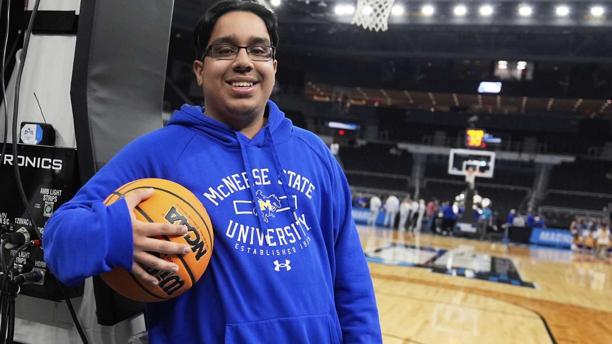 McNeese State men's basketball student manager Amir Khan smiles while posing after the team's practice at the NCAA college basketball tournament, Wednesday, March 19, 2025, in Providence, R.I.
