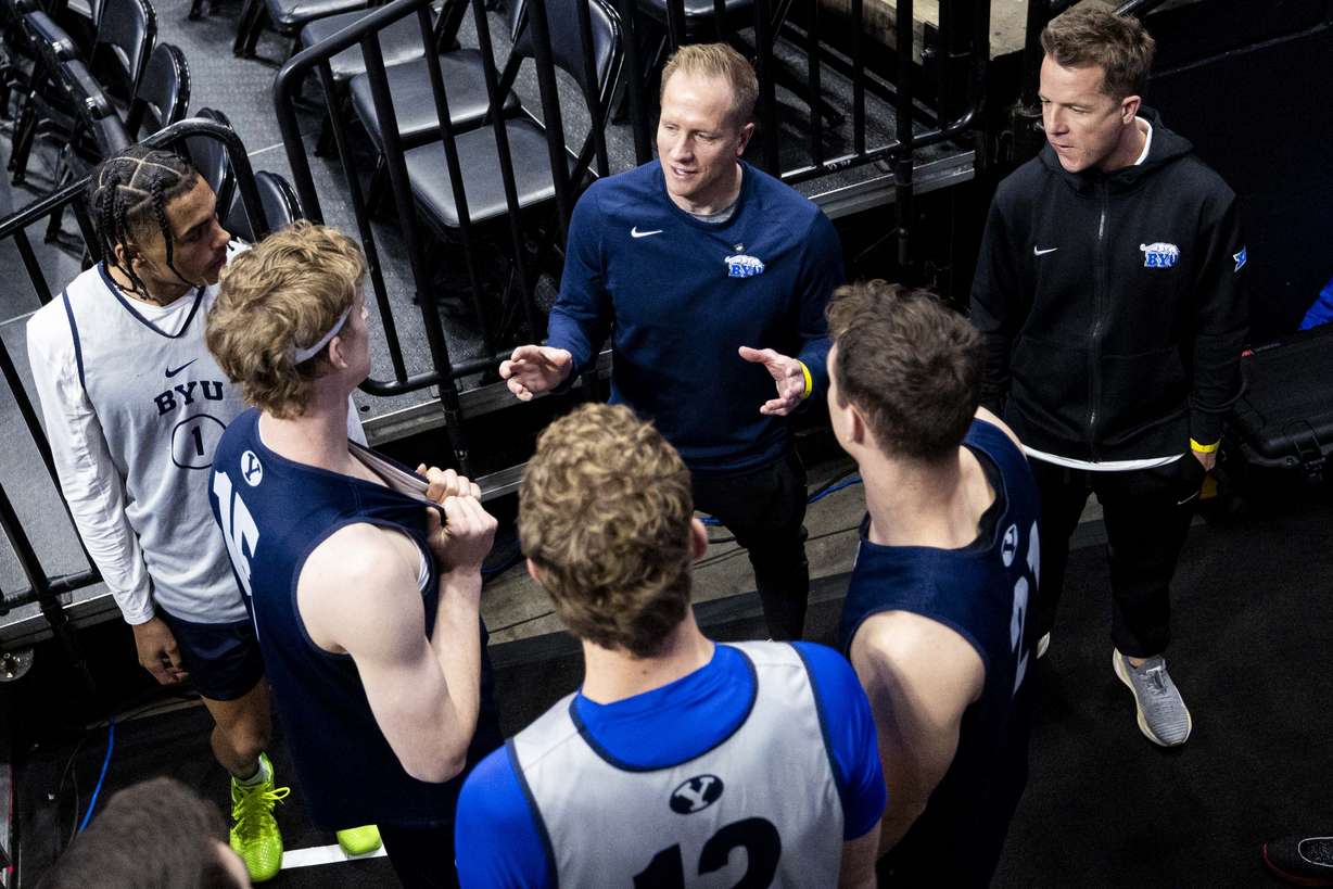 BYU Cougars head coach Kevin Young talks with his players before a practice held at Ball Arena in Denver, Colo., on Wednesday, March 19, 2025.