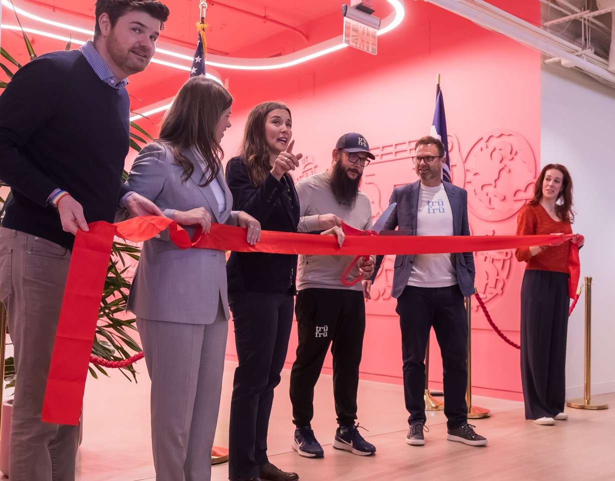 State and local leaders and Trü Frü employees cut a ribbon to celebrate the company's new corporate office at 170 S. Main in downtown Salt Lake City on Wednesday.