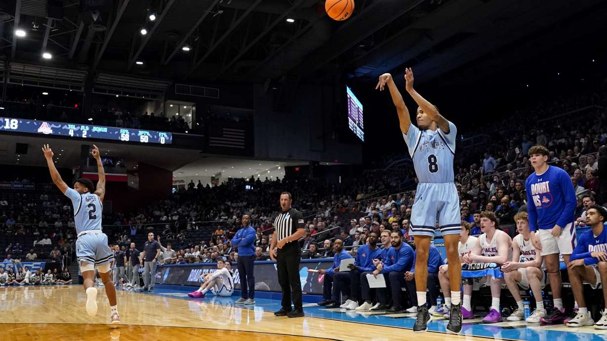 Mount St. Mary's Arlandus Keyes (2) reacts as teammate Dallas Hobbs (8) shoots during the first half of a First Four college basketball game against American University in the NCAA Tournament, Wednesday, March 19, 2025, in Dayton, Ohio.