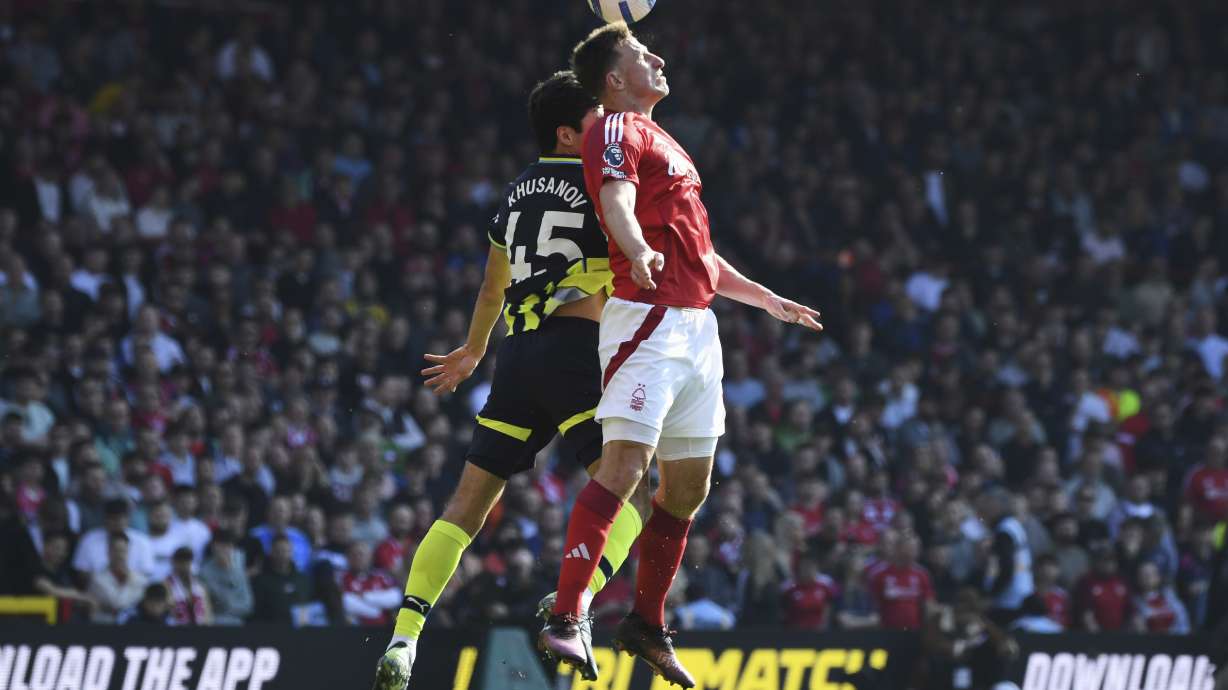 Nottingham Forest's Chris Wood, front, and Manchester City's Abdukodir Khusanov compete for the ball during the English Premier League soccer match between Nottingham Forest and Manchester City at the City Ground stadium, in Nottingham, England, Saturday, March 8, 2025.